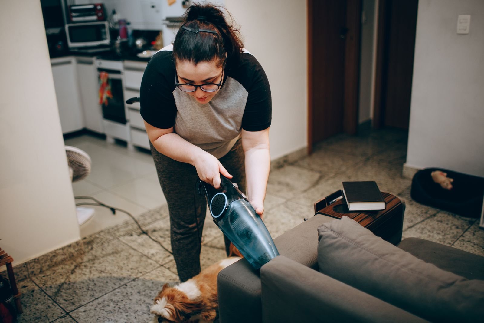 Vacuuming a sofa during upholstery cleaning